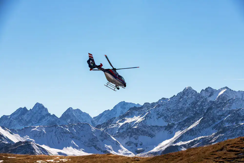Helicopter simulator flying over a mountain range