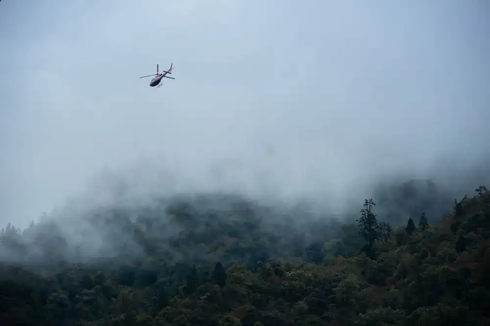 Helicopter approaching mountain landing site